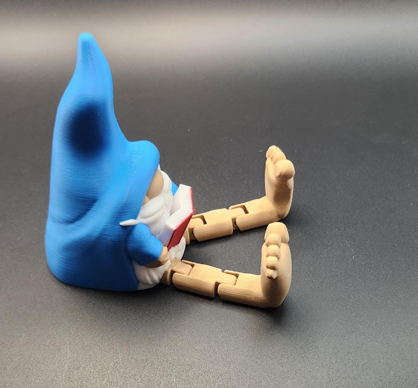 Blue hat book lover gnome ornament shelf buddy reading a red book sitting with wooden legs