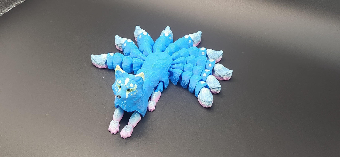Blue Japanese kitsune figurine 9-tailed fox mythical creature with intricate tail details on black background