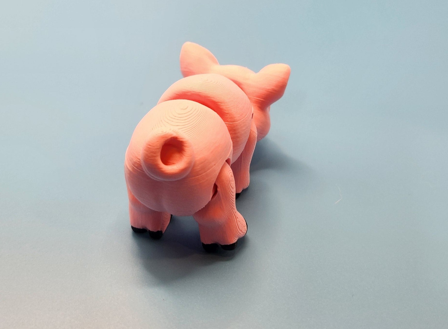 Pink toy pig on a light gray background