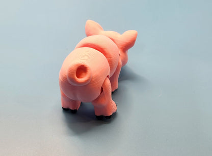 Pink toy pig on a light gray background