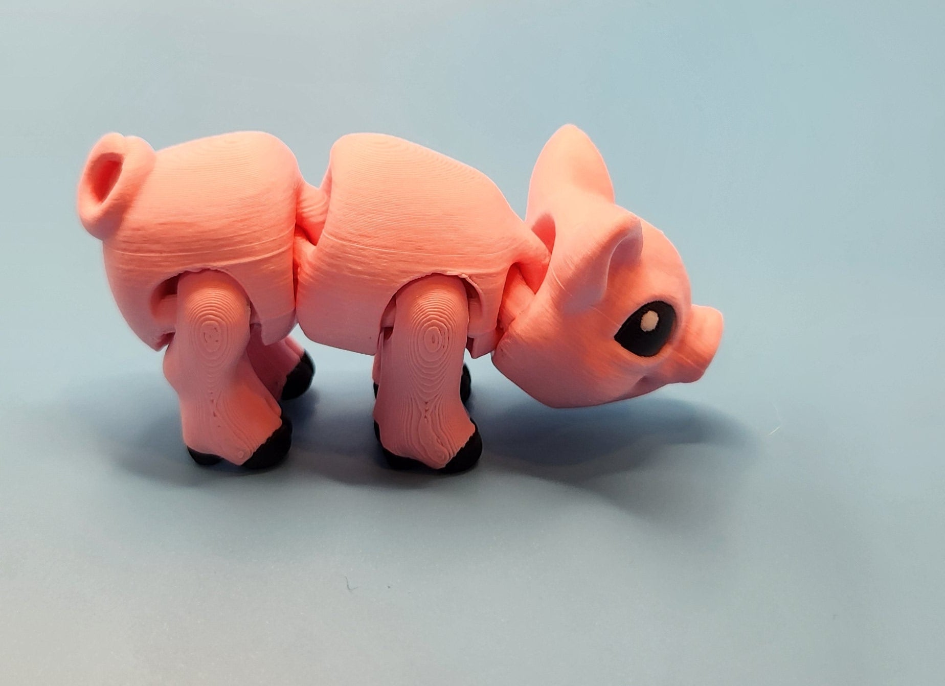 Pink toy figure on a light blue background