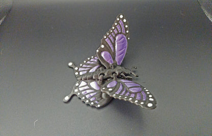 Etsy 3D printed butterfly figurine with purple and black detailed wings on a black background
