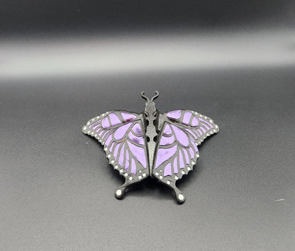 Purple and black 3D printed butterfly figurine with detailed wing patterns on black background
