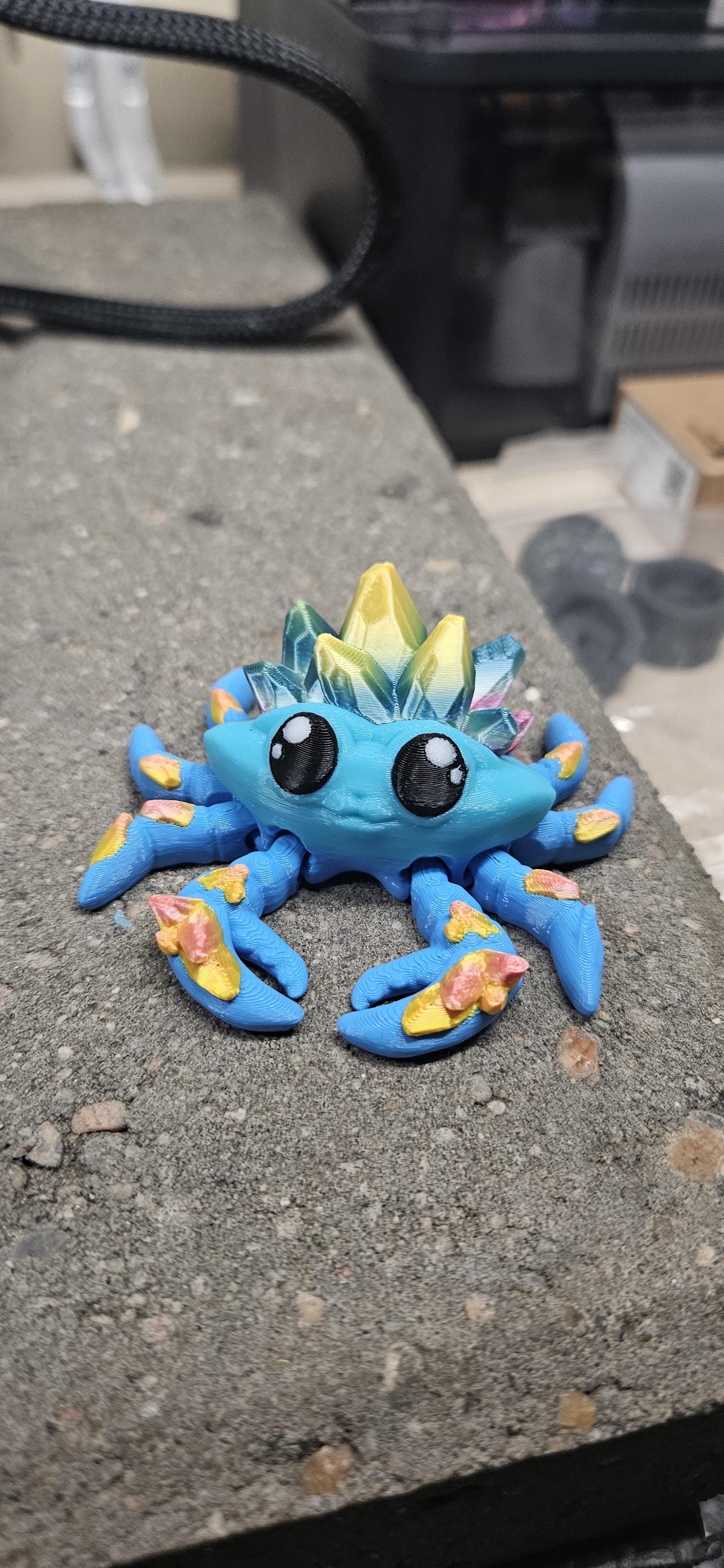 Colorful 3D printed crystal crab figurine in blue with crystal details on its back