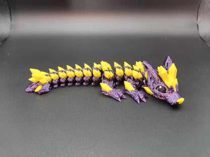 Purple and yellow 3D printed crystal dragon figurine with detailed scales and large eyes