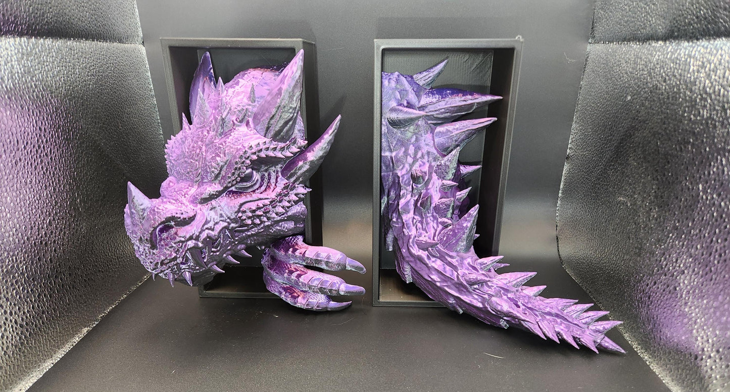 Purple 3D printed dragon bookend with detailed scales and spikes displayed in separate black frames