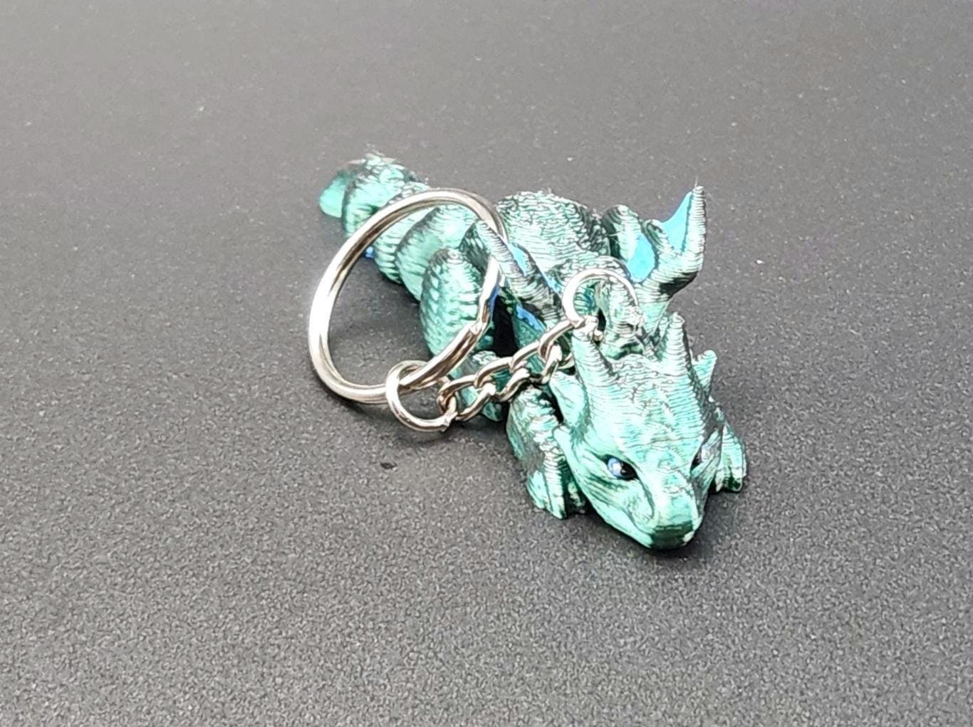 Etsy 3D printed dragon keychain in metallic teal with detailed scales and silver keyring