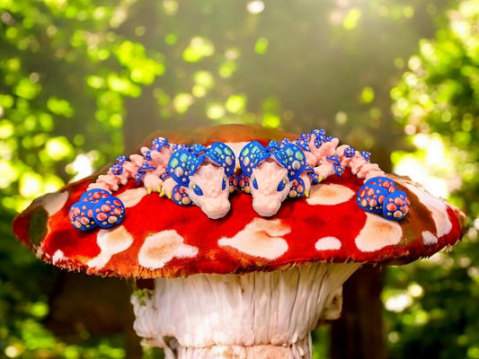 3D printed dragon mushroom toy featuring two blue and pink dragons on a red and white mushroom