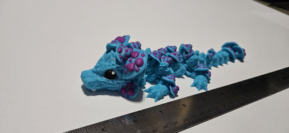 Blue and purple 3D printed dragon mushroom toy with detailed spikes and black eyes next to a ruler for size