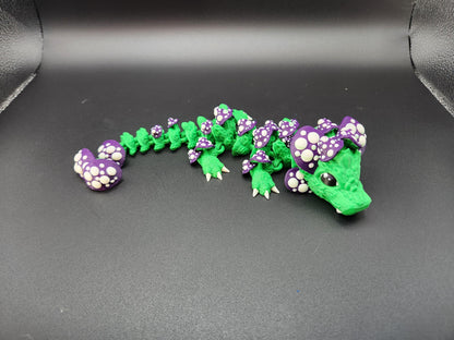 Green and purple 3D printed dragon mushroom toy with spotted mushroom details on black background