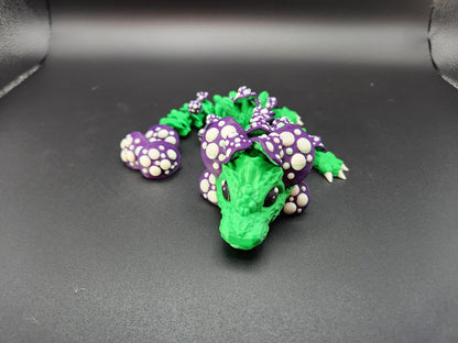Green and purple 3D printed dragon mushroom toy with detailed scales and mushroom spots on black background
