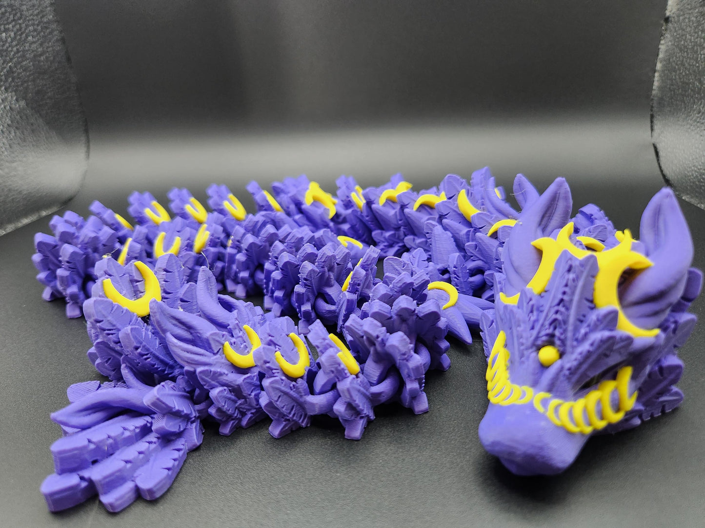 Purple and yellow 3D printed lunar dragon figurine with detailed scales and facial features