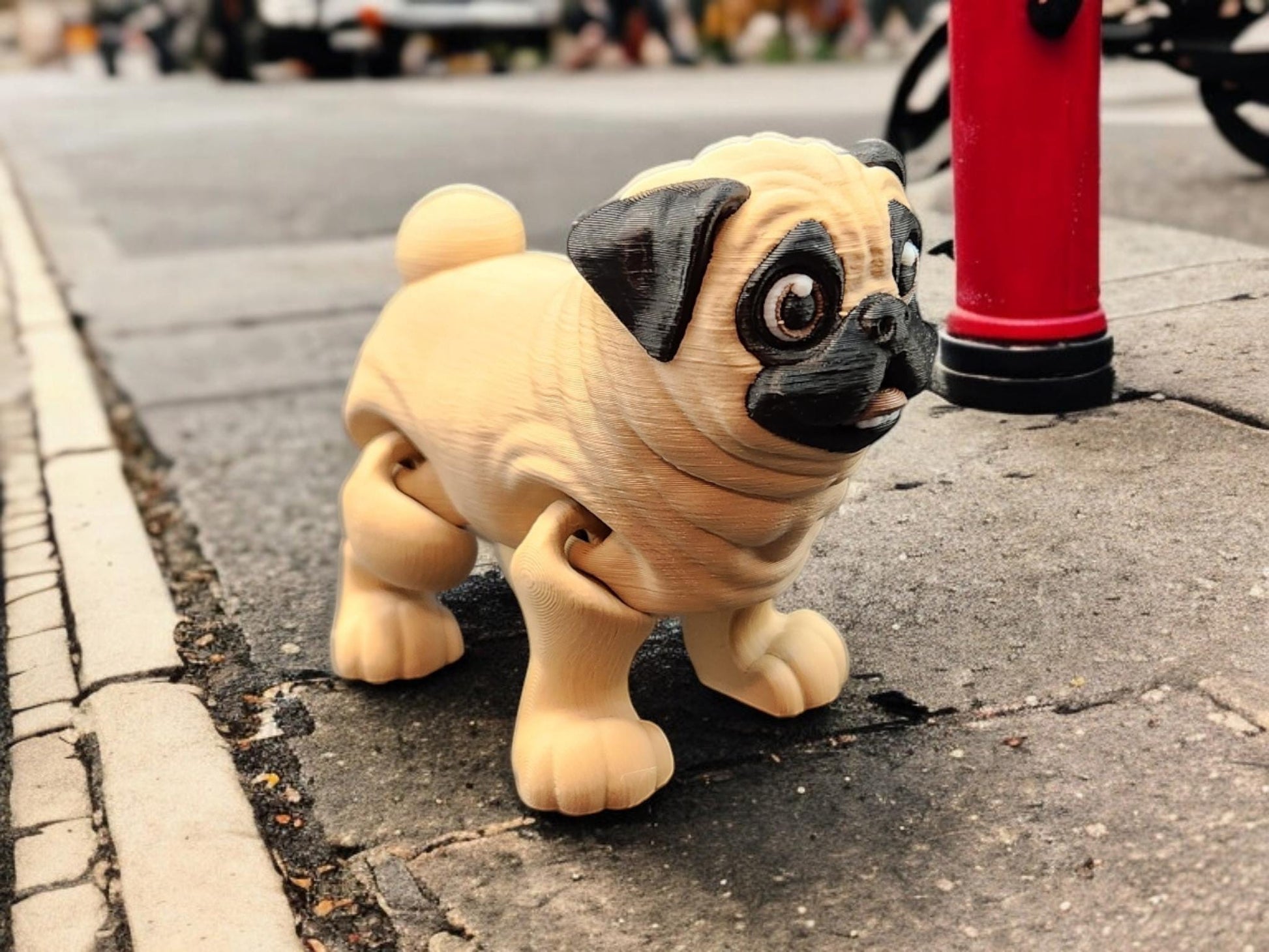 Close-up of a 3D printed pug toy with detailed facial features