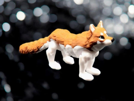 3D printed realistic wolf figurine in orange and white colors with detailed fur texture