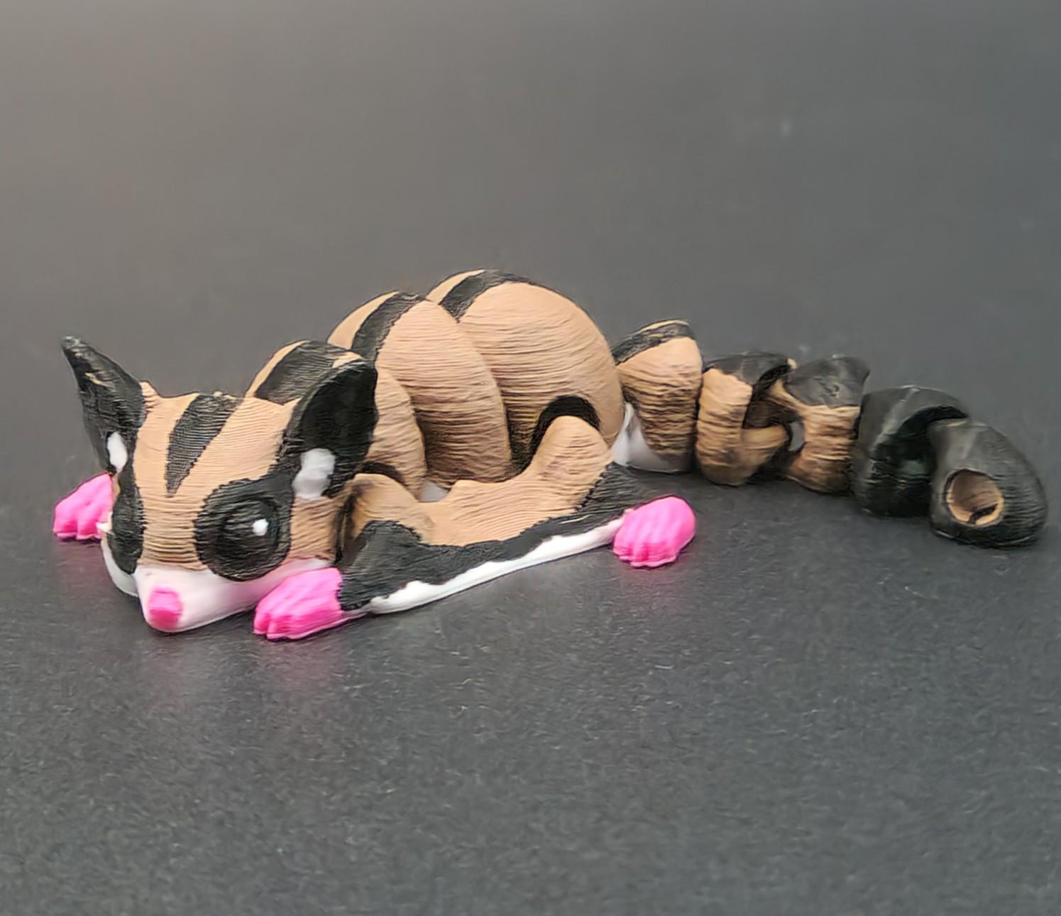 3D printed sugar glider keychain featuring a detailed brown and black sugar glider with pink feet