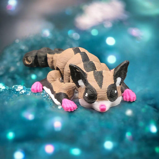 Cute 3D printed sugar glider keychain with pink paws and detailed black and tan markings