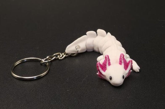 White and pink articulated axolotl keychain with movable segments attached to a metal ring