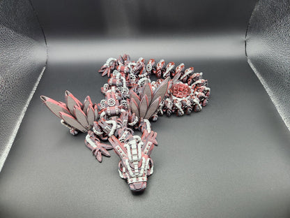 Articulated steampunk dragon figurine with detailed mechanical wings and segmented body on black background