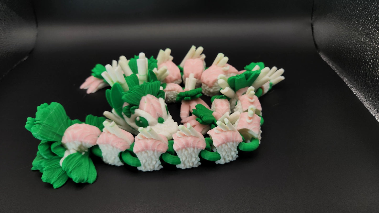 Articulated sushi dragon figurine in pink green and white with detailed sushi roll design on black background