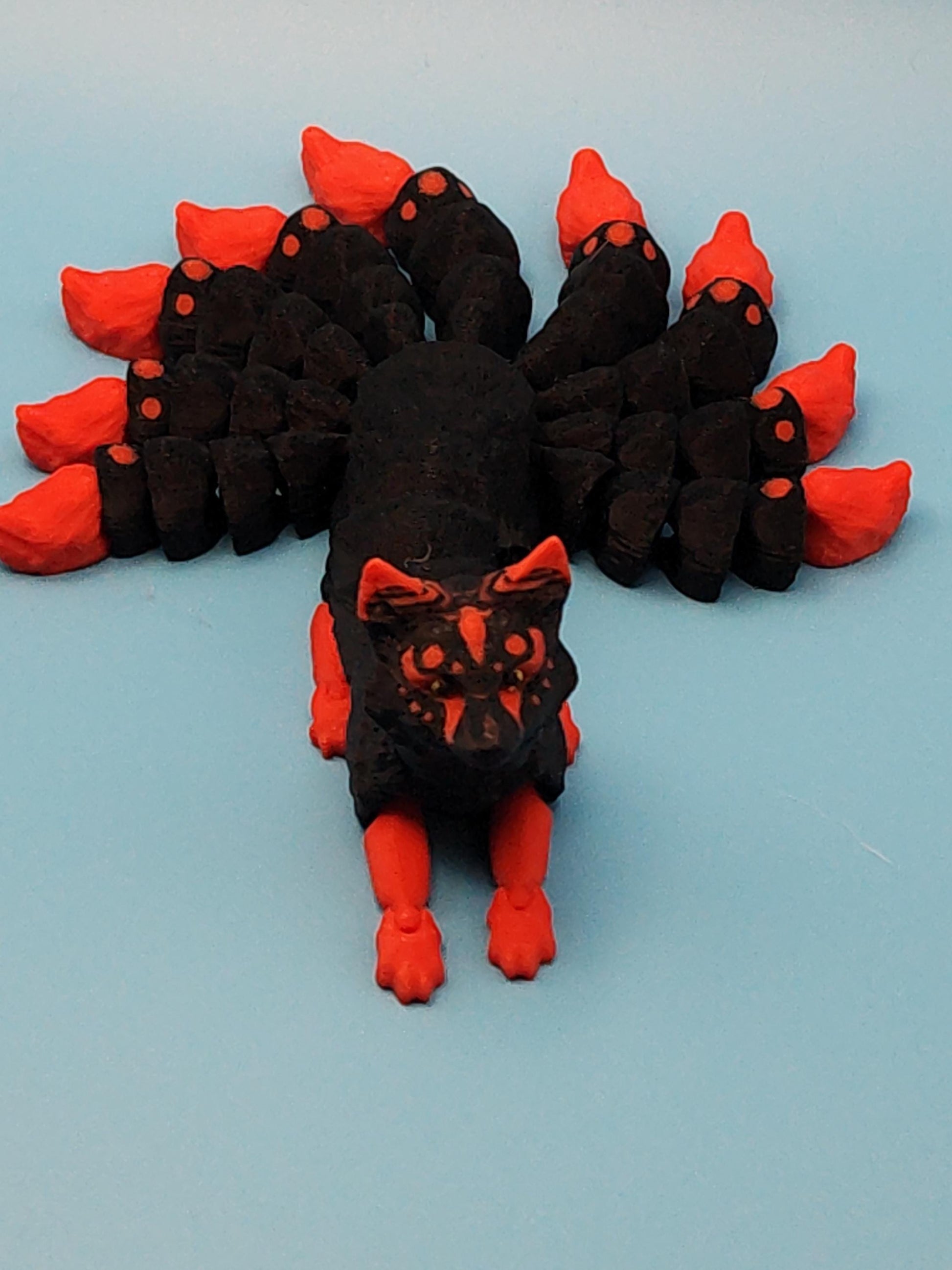 Black and red Japanese kitsune figurine 9-tailed fox mythical creature with detailed tails and face