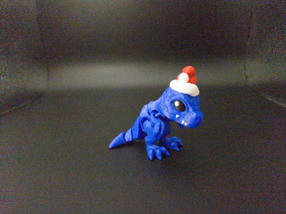 Blue Christmas Santa T-Rex figurine wearing a red and white Santa hat 