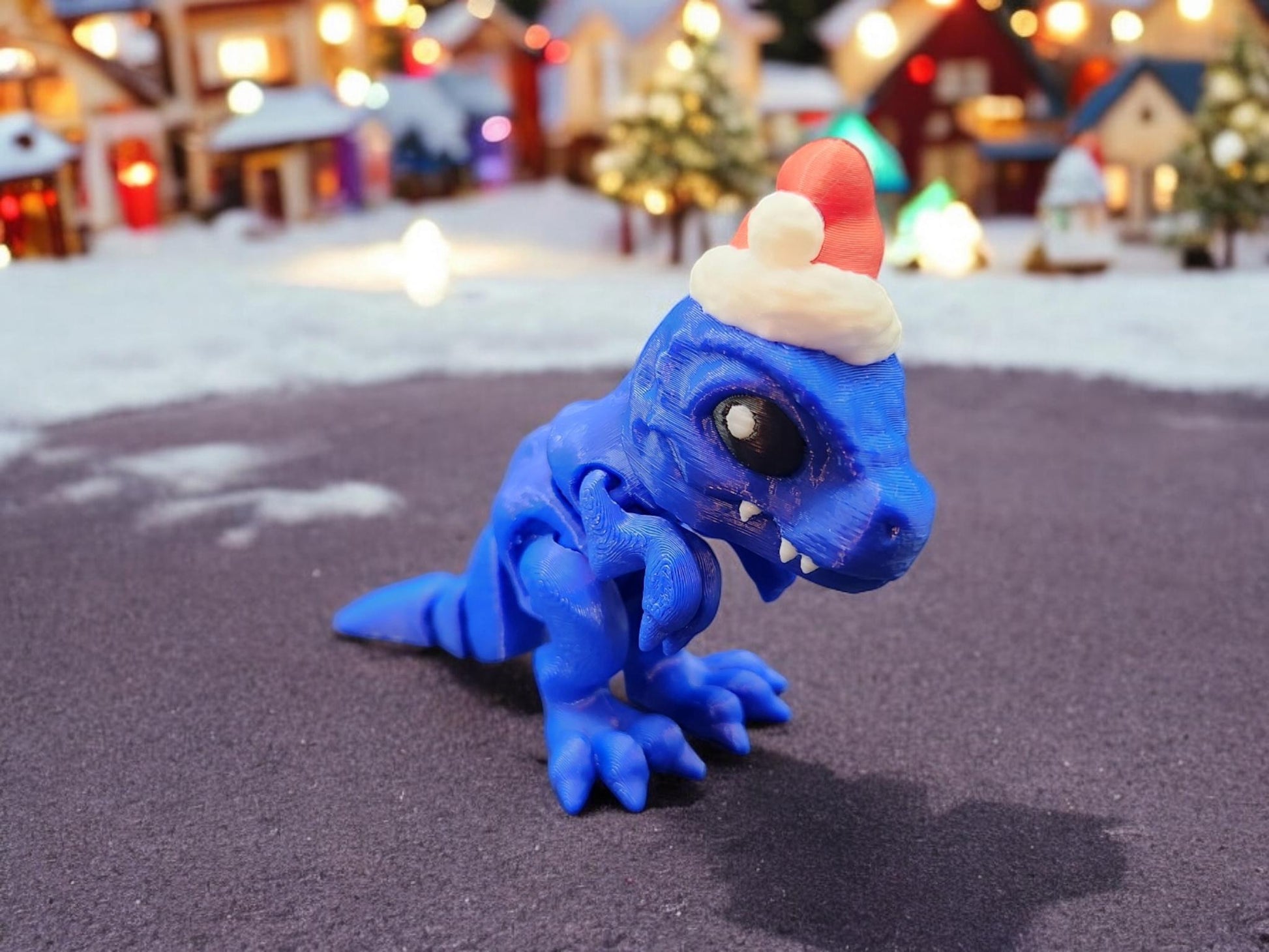 Blue Christmas Santa T-Rex figurine wearing a red and white Santa hat on a festive background
