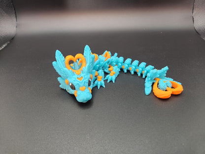 Cute flexy heart dragon figurine in blue with orange heart accents and detailed scales