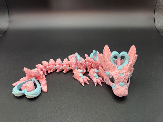 Cute flexy heart dragon figurine in pink and blue with heart-shaped details on black background