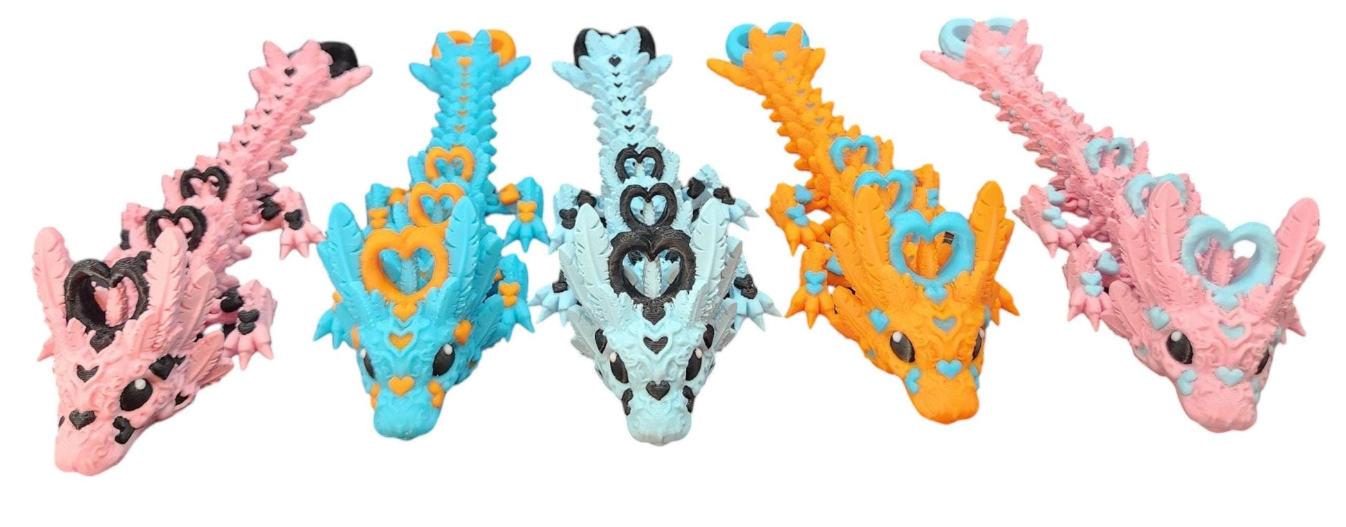 Cute flexy heart dragon figurine in various pastel colors displayed in a row on white background