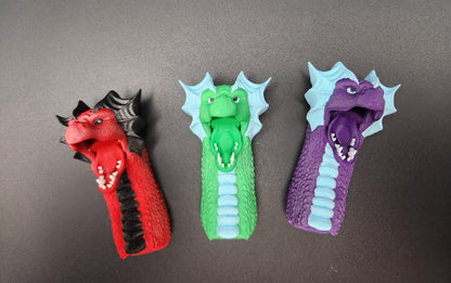 Set of three colorful fantasy dragon finger puppets in red, green, and purple with detailed scales and wings