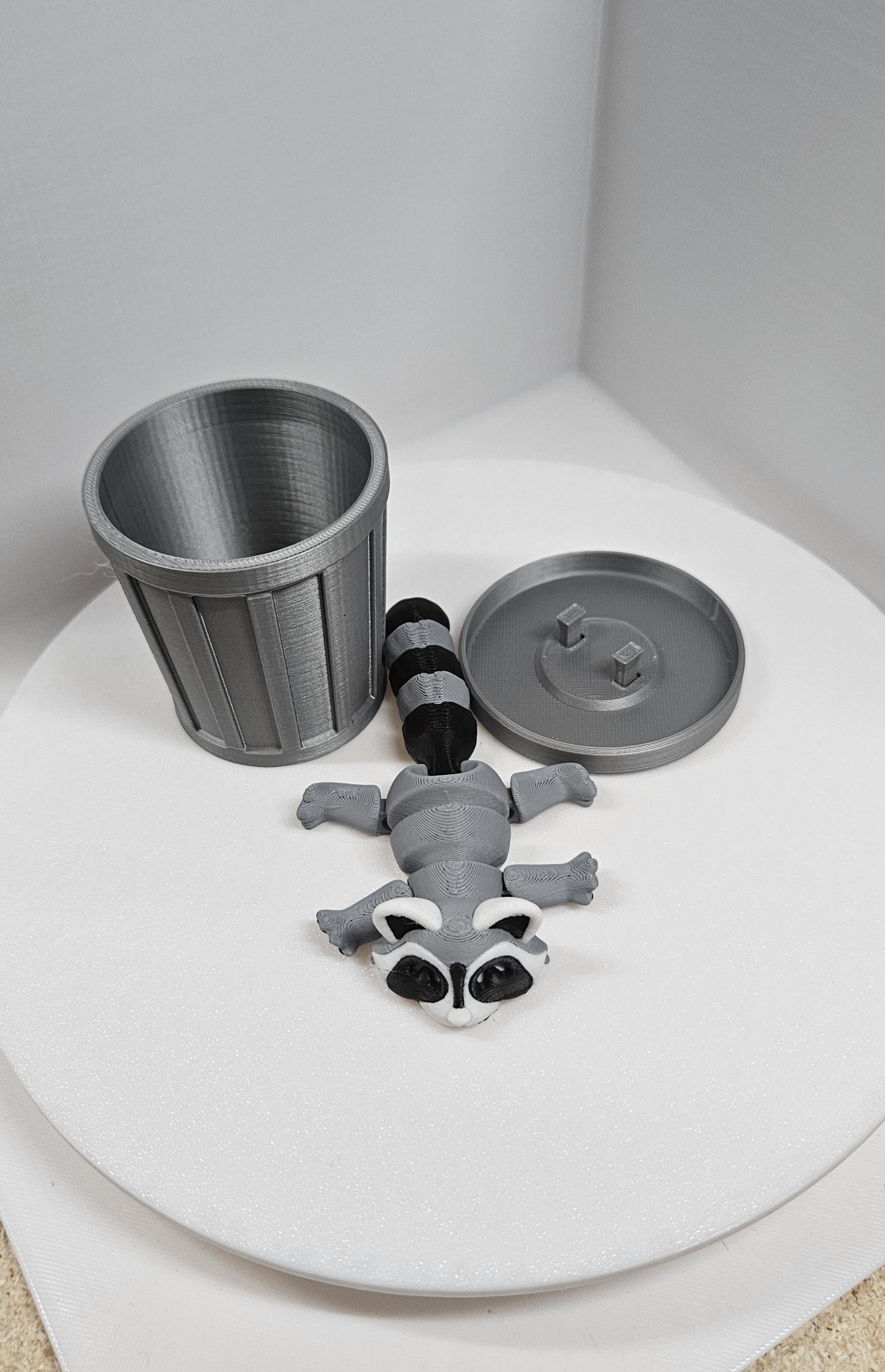 Articulated raccoon fidget figure with removable trash can and lid on white background