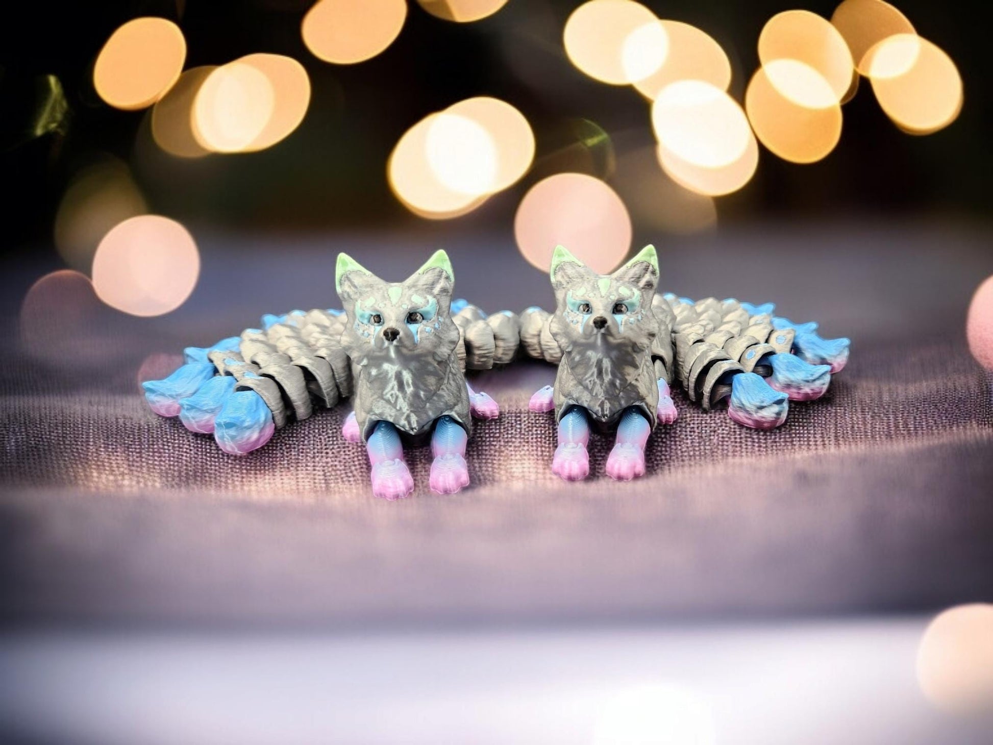 Pair of handcrafted Japanese kitsune figurine 9-tailed fox mythical creature in pastel blue and pink accents