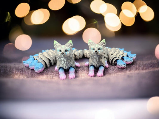 Pair of handcrafted Japanese kitsune figurine 9-tailed fox mythical creature in pastel blue and pink accents