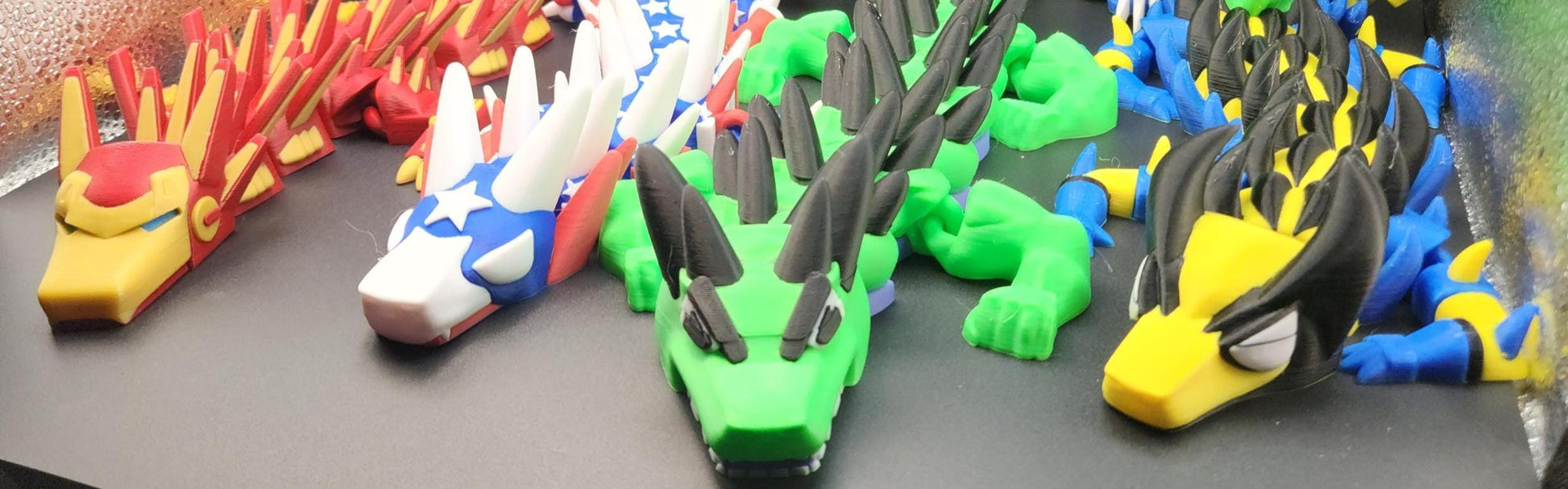 Legend inspired dragon action figures in multiple colors including red, white, green, and yellow displayed on a table