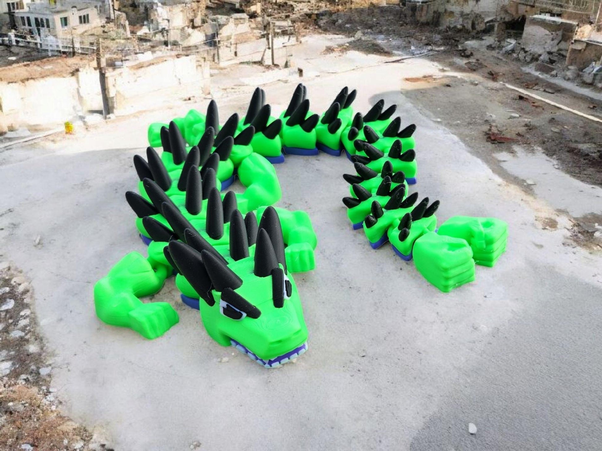 Bright green legend inspired dragon action figures with black spikes displayed outdoors on concrete