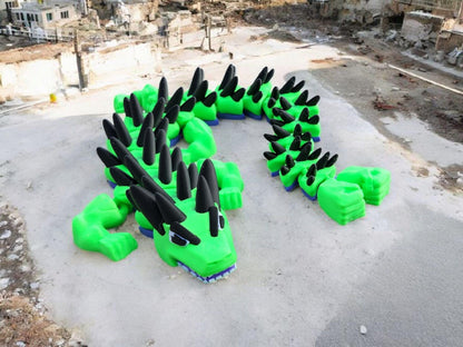 Bright green legend inspired dragon action figures with black spikes displayed outdoors on concrete