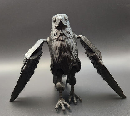Black articulated raven figurine with detailed feathers and movable wings displayed on gray background