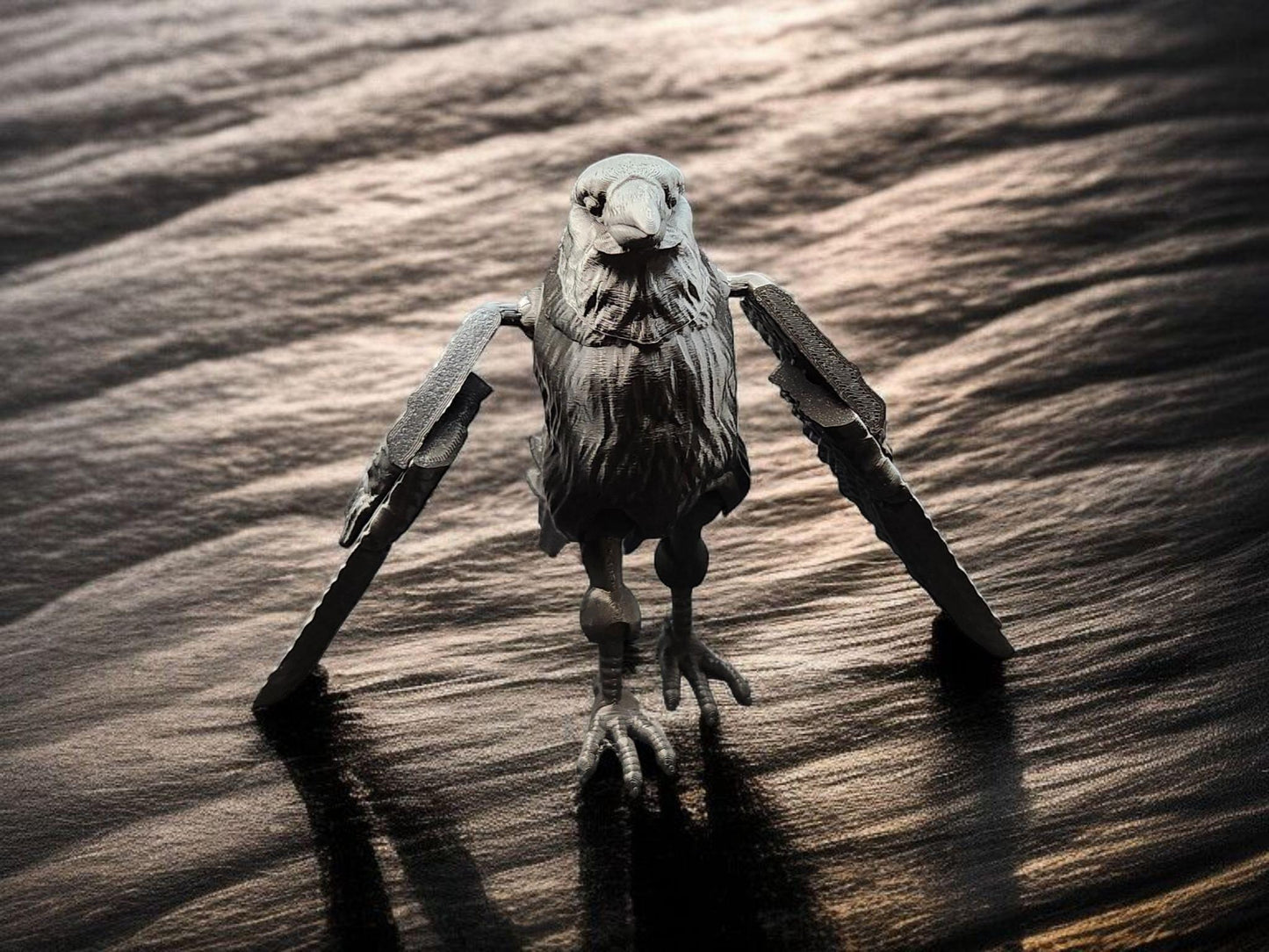 Black articulated raven figurine with movable wings standing on a textured dark surface