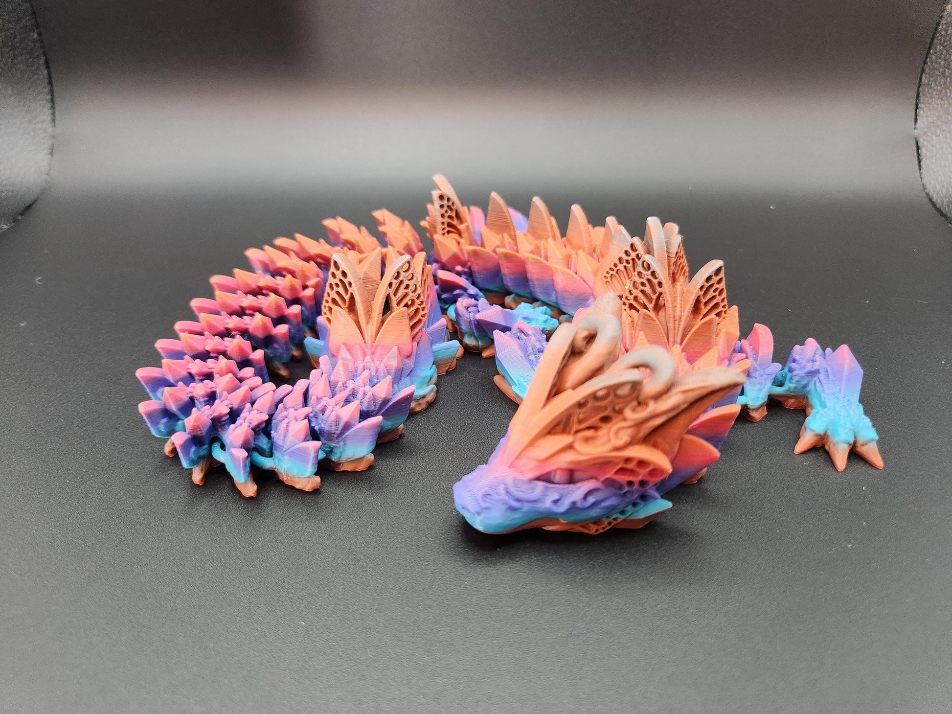 Multicolor fae dragon decor with detailed wings and scales in pink, purple, and blue hues