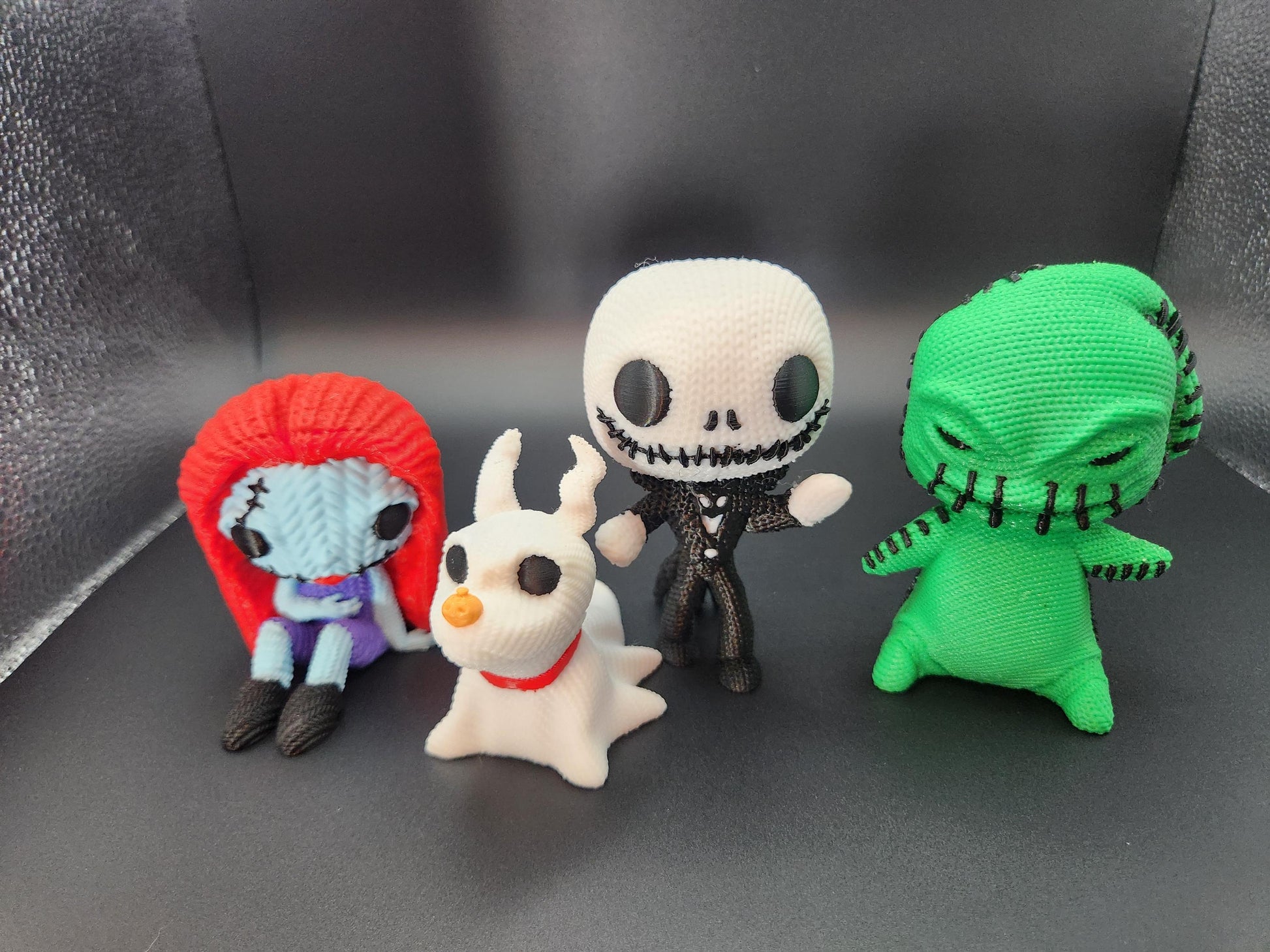 Unique crochet Nightmare Before Christmas gifts featuring handmade Sally, Zero, Jack Skellington, and Oogie Boogie dolls