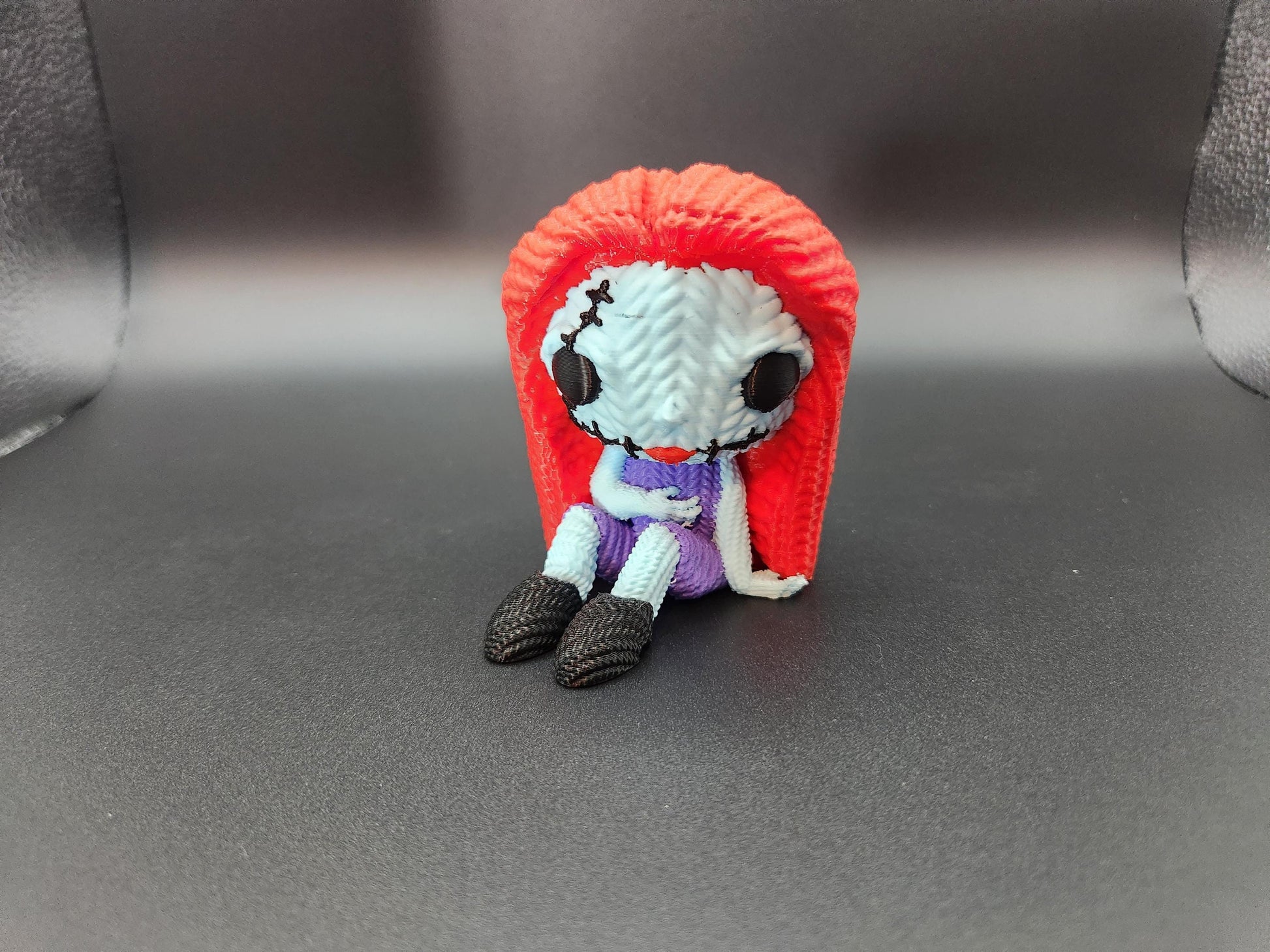 Unique crochet Nightmare Before Christmas gifts featuring handmade Sally doll with red hair and purple dress