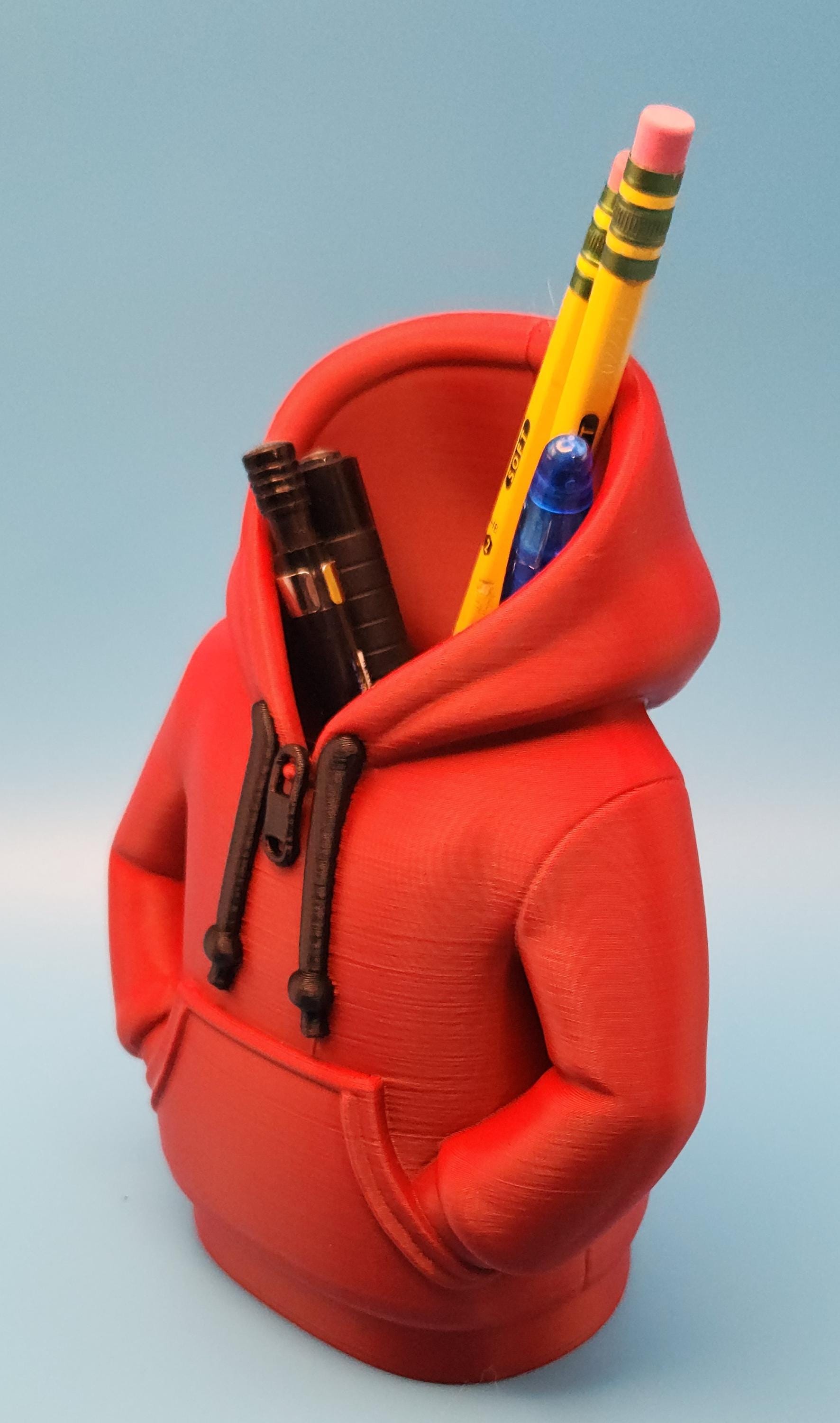 Red hoodie shaped novelty pencil cup for office holding pencils and pens on blue background