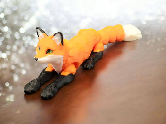 Realistic 3D printed Articulated fox figurine with orange body black legs and white tail tip