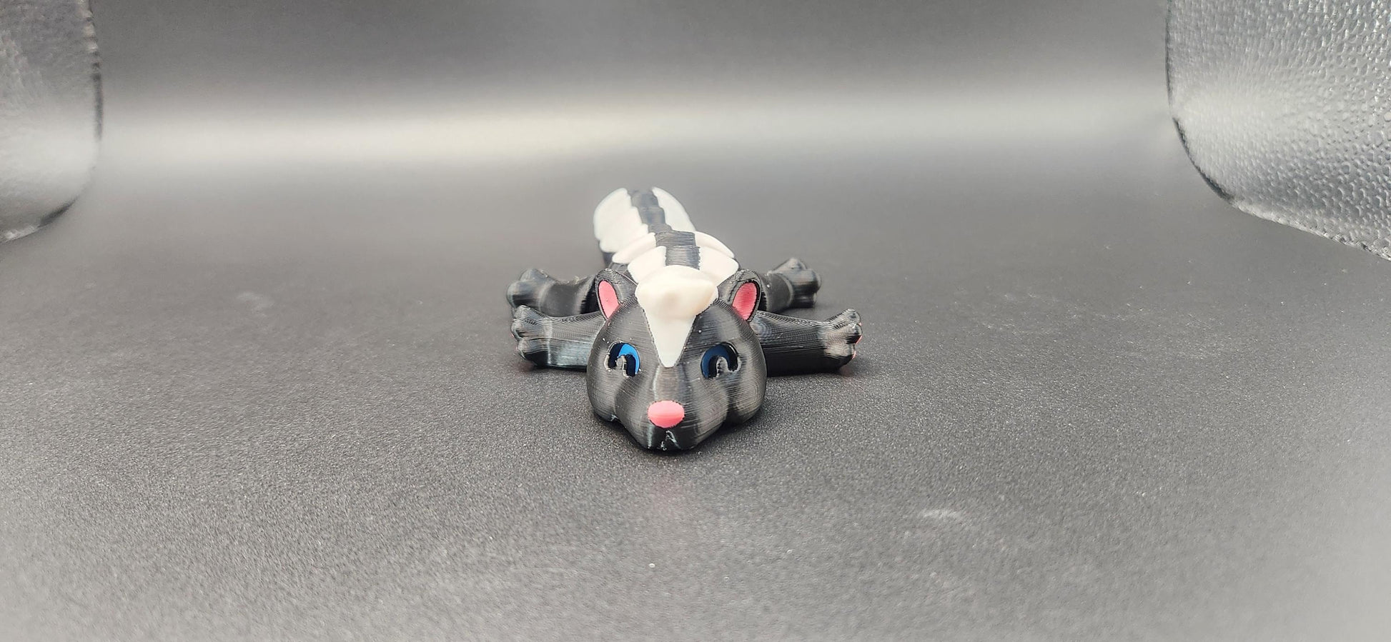 Realistic articulated Skunk Fidget toy with detailed black and white design and movable limbs