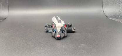 Realistic articulated Skunk Fidget toy with detailed black and white design and movable limbs