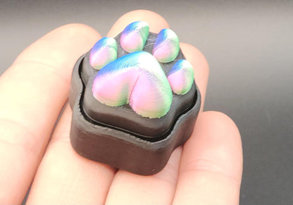 Rainbow-colored sensory stress relief clicker shaped like a cat paw