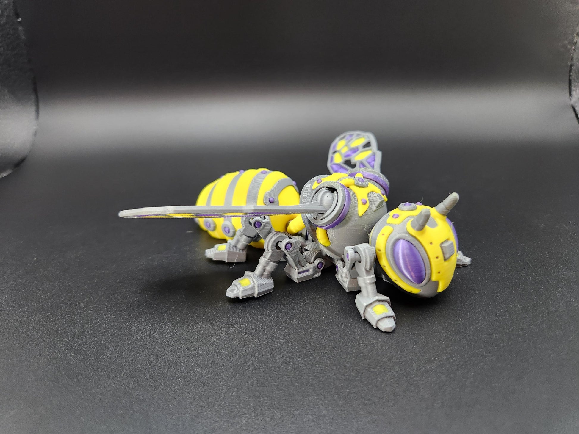 Steampunk mech bee collectible in yellow and purple with detailed mechanical legs and wings