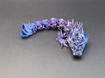 3D printed baby dragon figurine in purple and blue with detailed floral and spike design