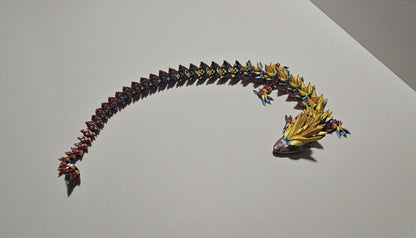 3D printed crystal dragon figurine with detailed multicolor scales and elongated body on a white background