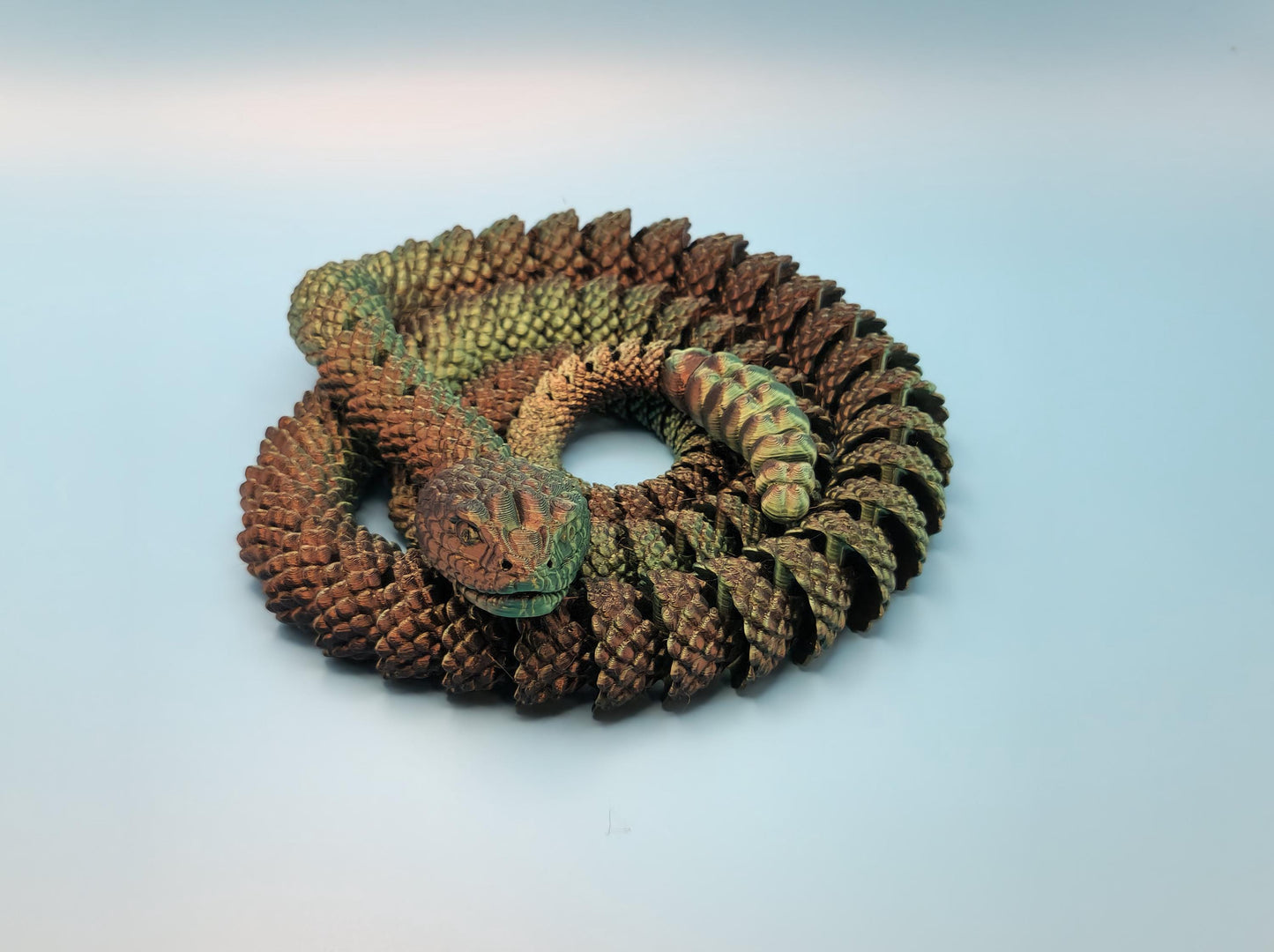 3D printed rattlesnake toy coiled with detailed scales and realistic texture in brown tones